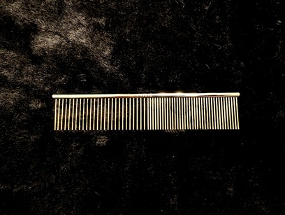 steel-comb-on-black-surface
